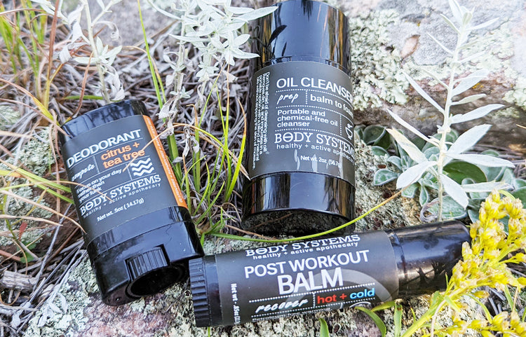 Athletic Skincare essentials including Muscle Balm, Deodorant and Oil Cleansing Stick. Shown outside in Custer State Park